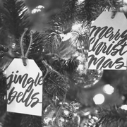 Gift tags hanging from a Christmas tree