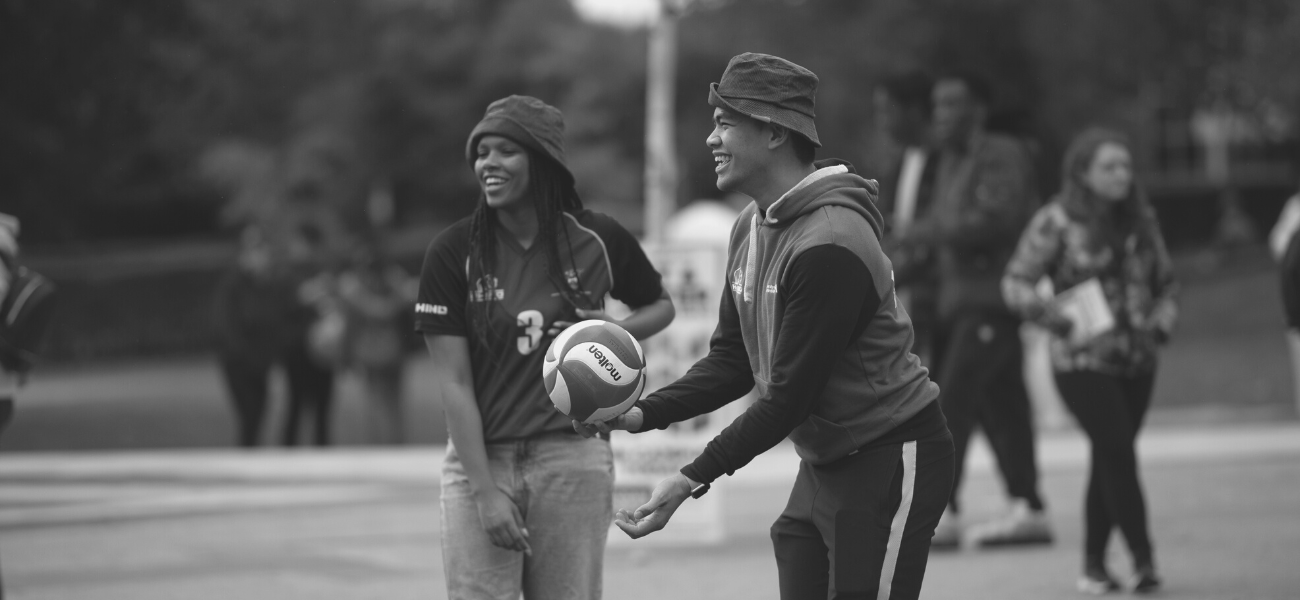 Students playing volleyball on campus