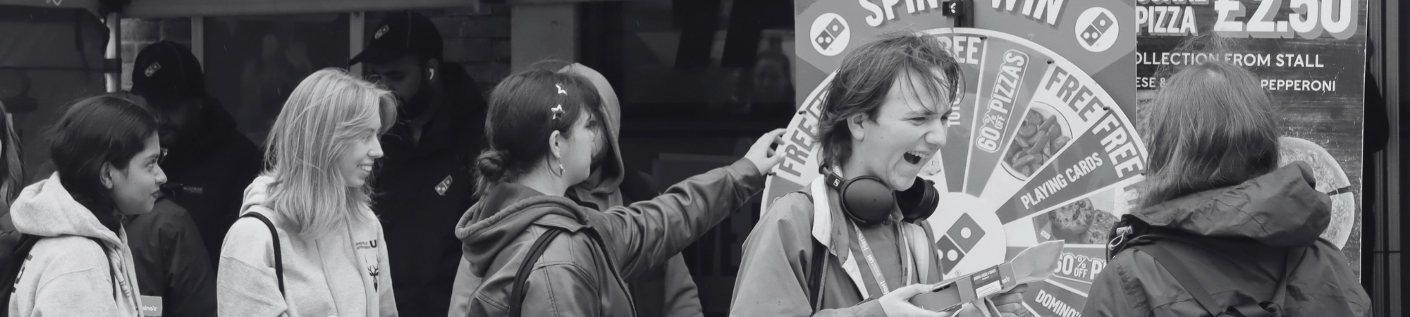 Students engaging with a Domino's stall