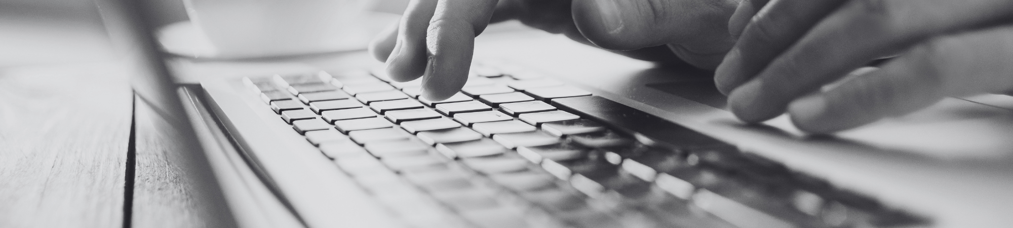Student typing on laptop keyboard