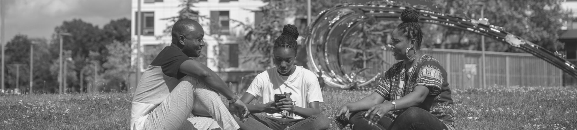 Students relaxing outside halls of residence