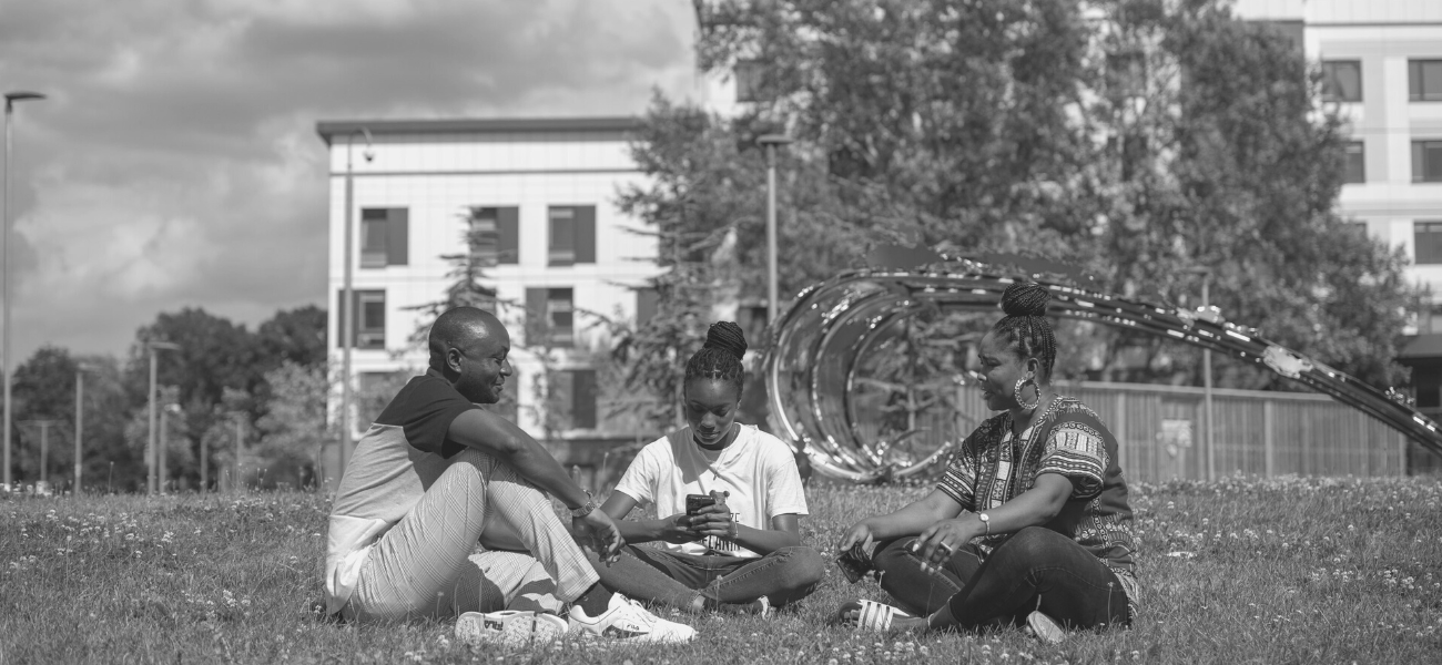 Students relaxing outside halls of residence