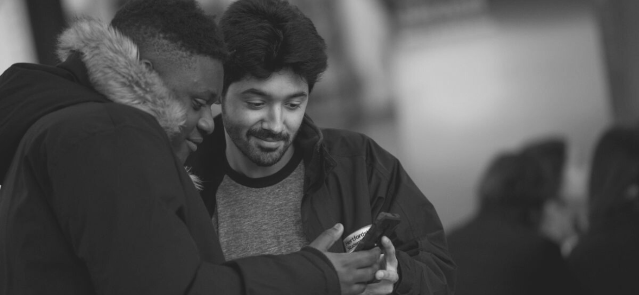 Staff members looking at a phone