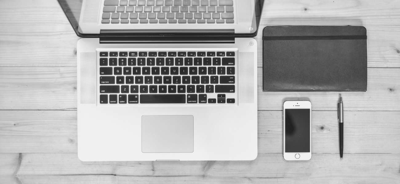 Laptop, phone, notepad and pen