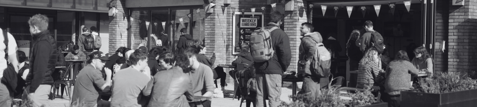 Photo of students sitting outside the EleHouse